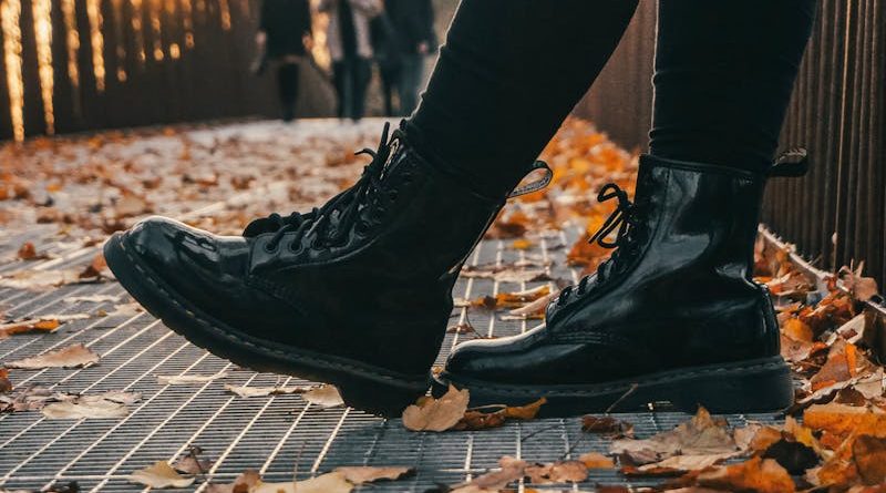 Low Angle Photo of Person Wearing Black Boots and Black Pants