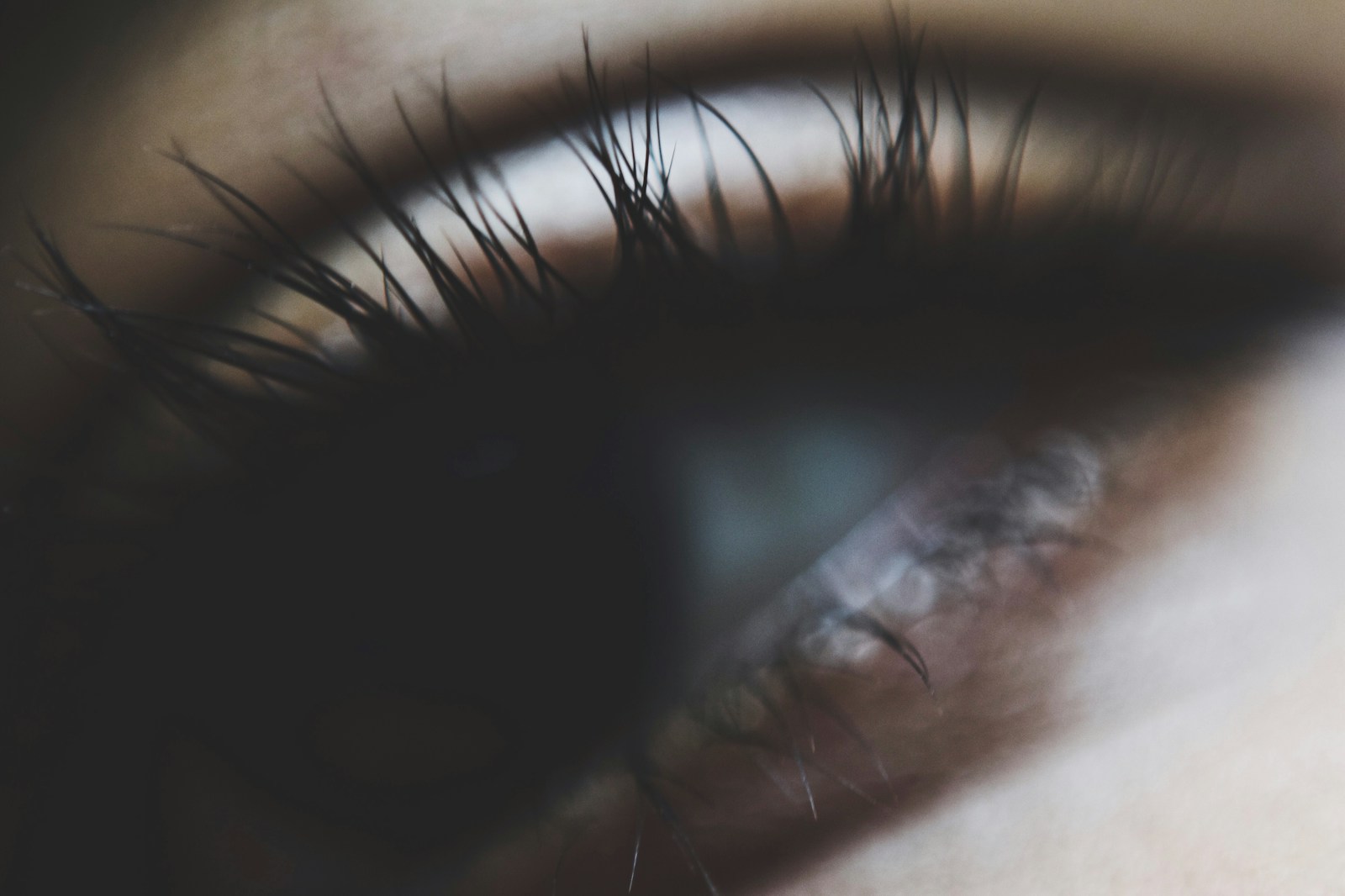 a close up of a person's eye with long eyelashes